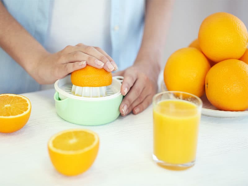 Hands Making Orange Juice