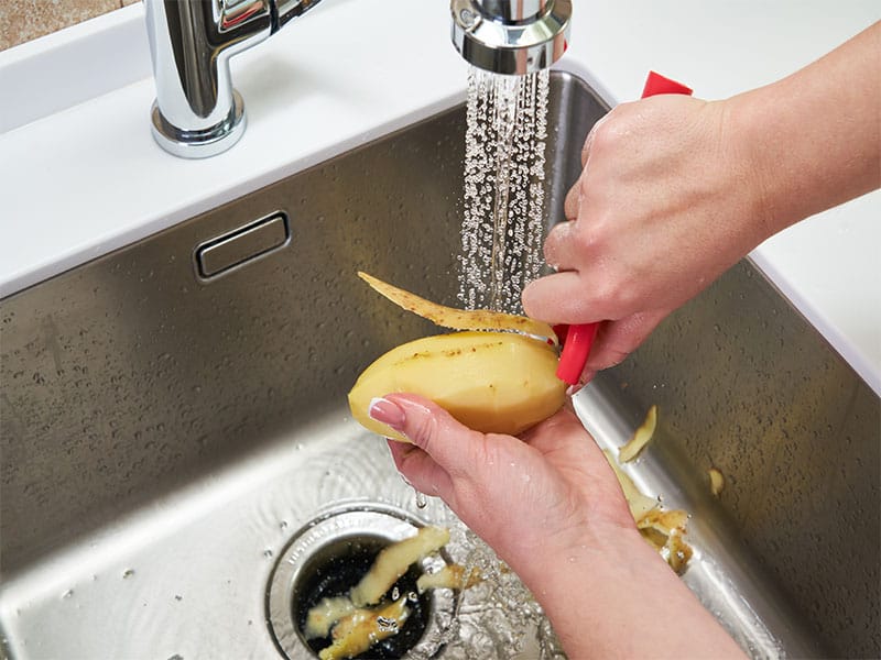 Hands Peeling Potato
