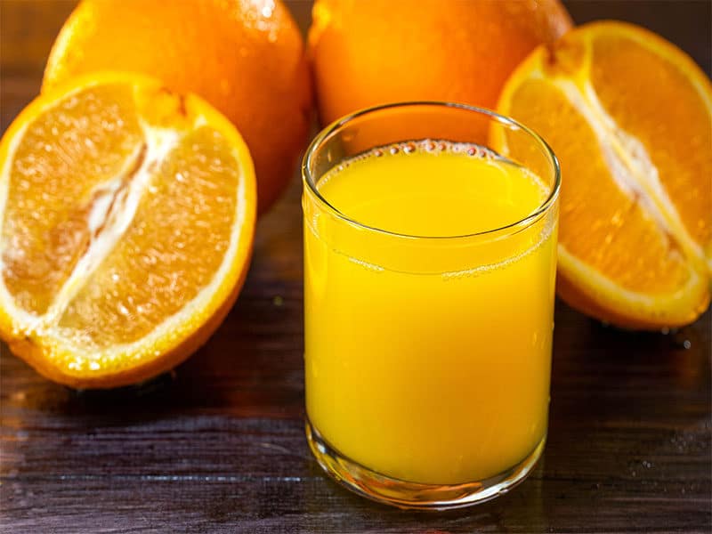 Oranges Juice Shot On Wooden