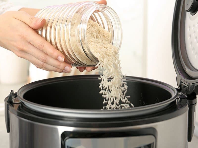 Woman Pouring Rice Jar