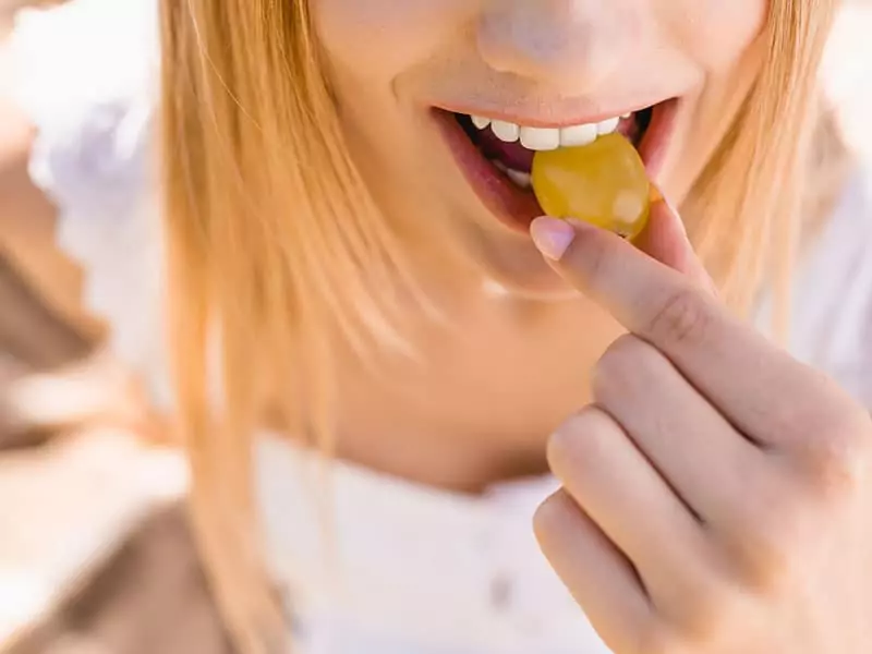 Young Woman Eating Grapes