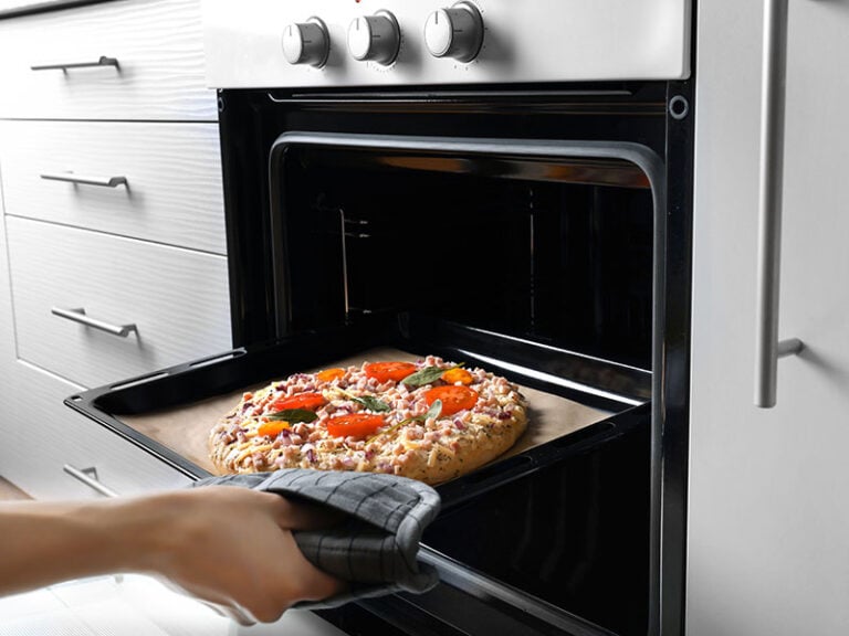 Putting Baking Sheet Pizza Oven