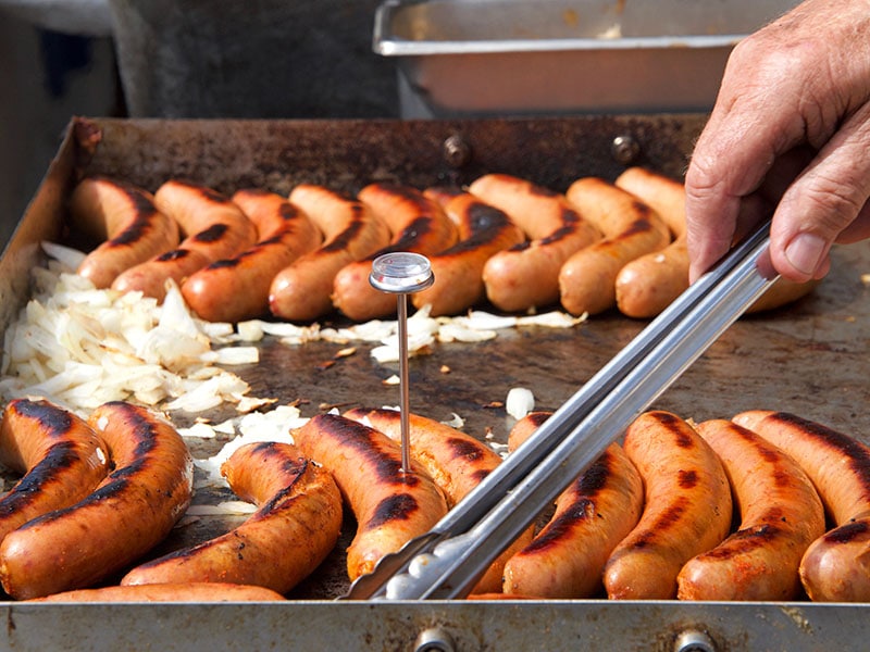 Tongs Turning Sausage