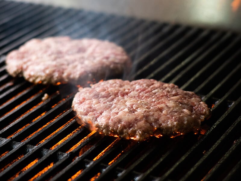 Burgers on Hot Grill Flames