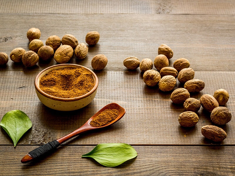 Nutmeg on Wooden Background