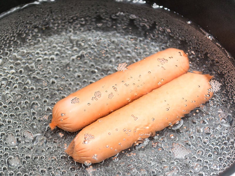 Two Sausages Are Boiling In Water