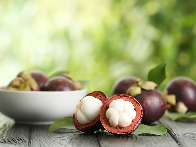 Mangosteen Fruits On Wooden