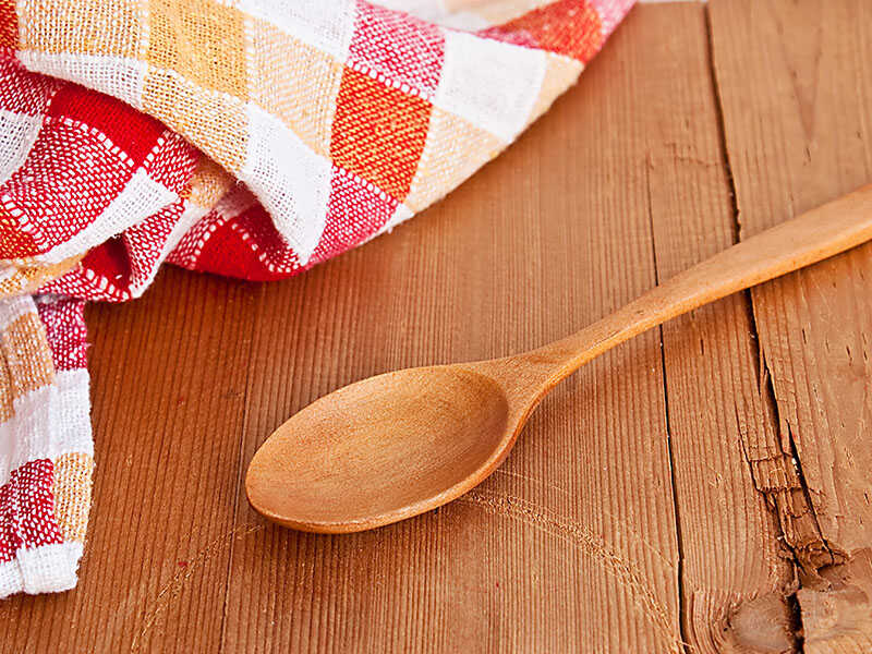 Wooden Spoon And Kitchen Towel