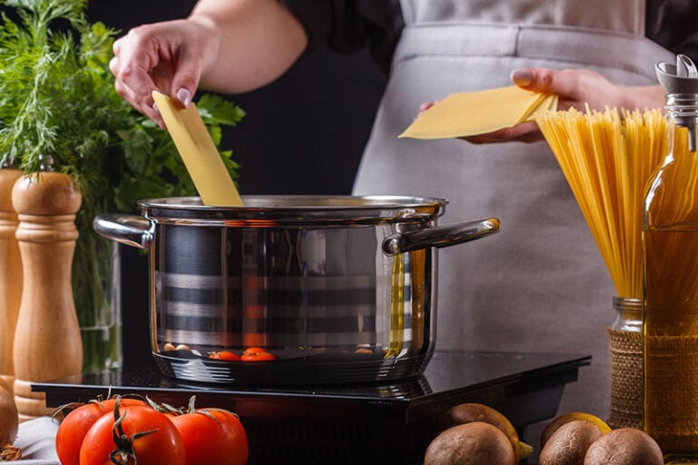 Gray Apron Preparing Pasta