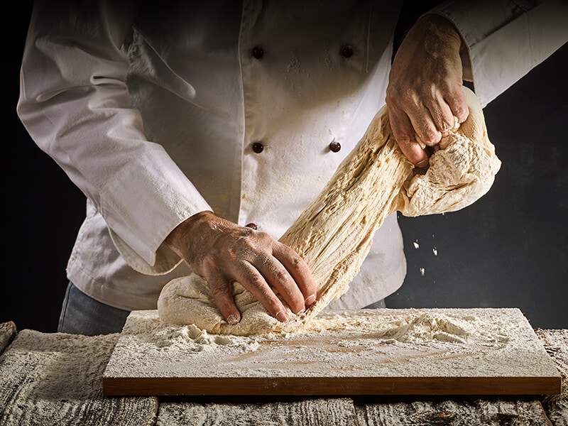 Chef Stretching Raw Dough