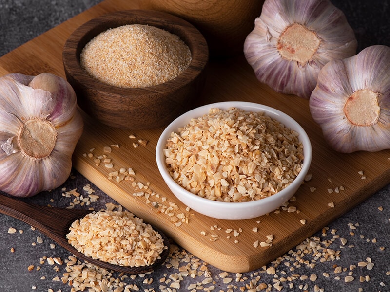 Dry Garlic Powder In Wooden Bowl