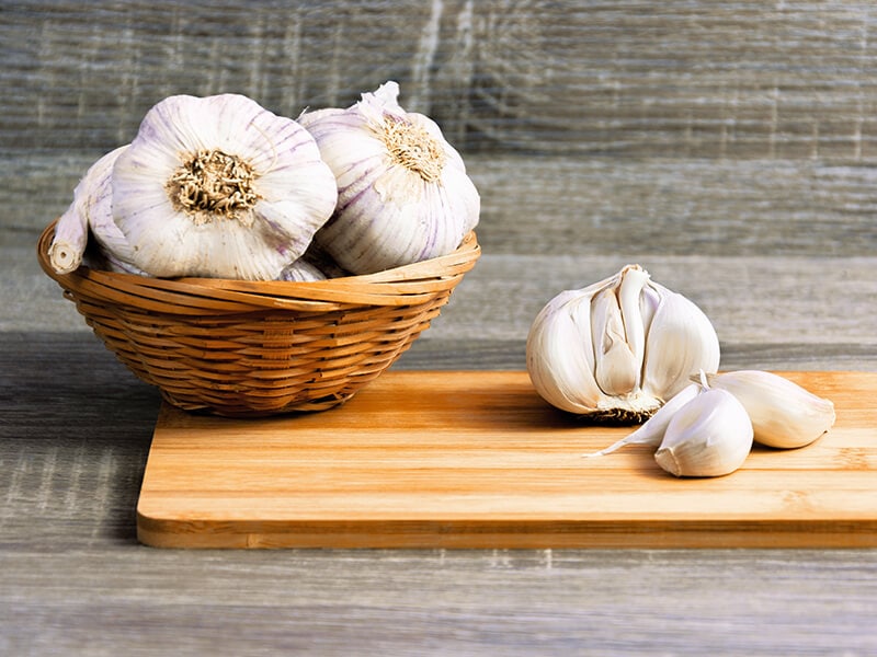 Garlic Cloves On A Wooden Cutting Board