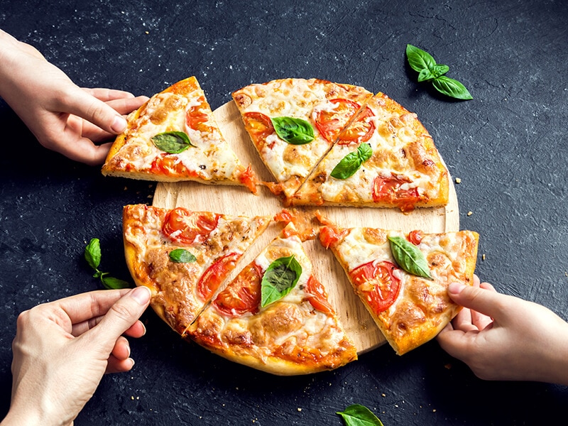 Hands Taking Slices Pizza