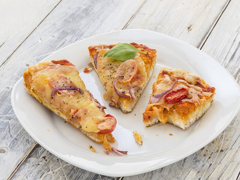 Leftover Pizza On Rustic Wooden Table