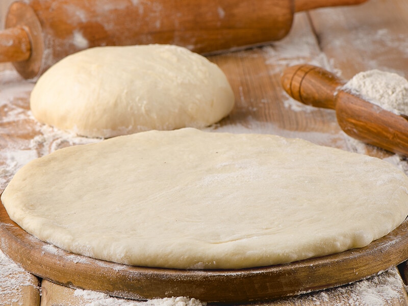 Pizza Dough On Wooden Board