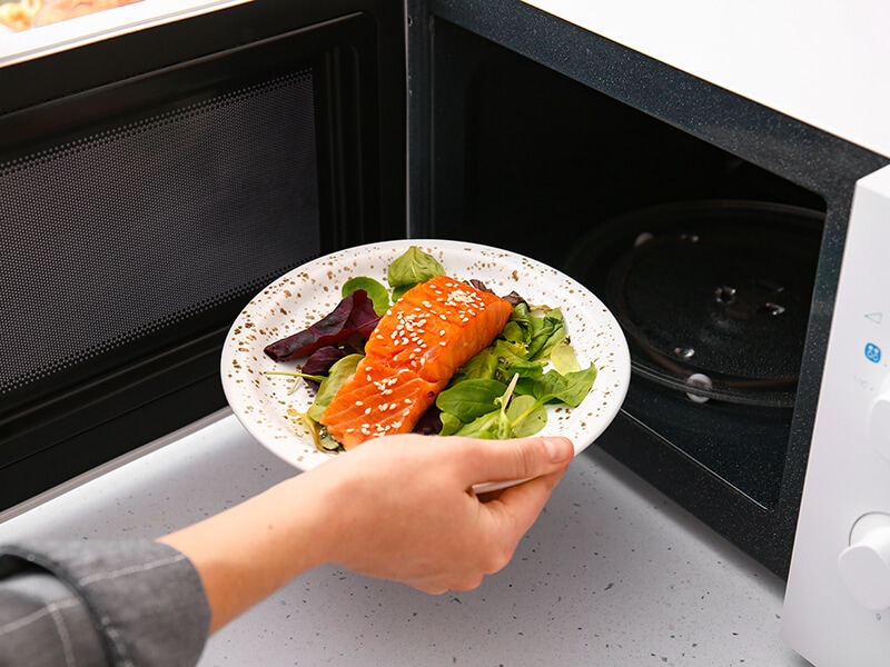 Woman Putting Salmon